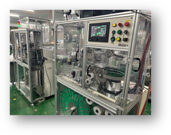 テーピング梱包自動機